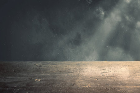 Wooden table with dark backgroundの写真素材