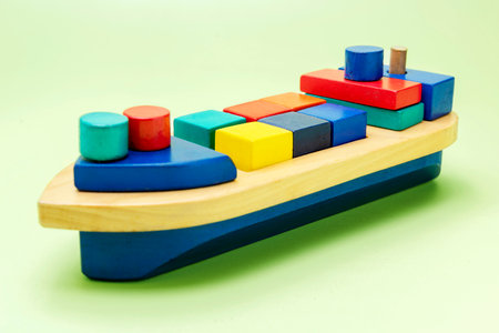 A colorful wooden toy ship on a colored backgroundの写真素材