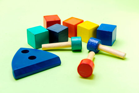 Colorful wooden block toys on a colored background