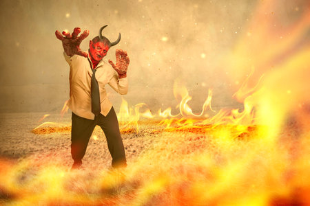 Devilman is standing with fire's background. Halloween concept