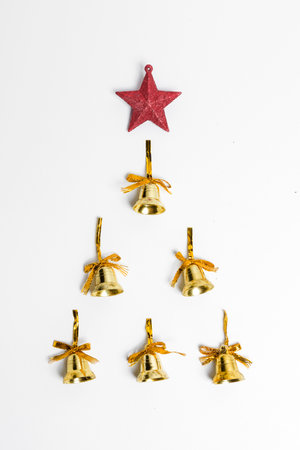 Golden Christmas bell with Christmas star on white background. Christmas decoration