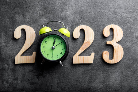 2023 with a clock with a black background. Happy New Year 2023