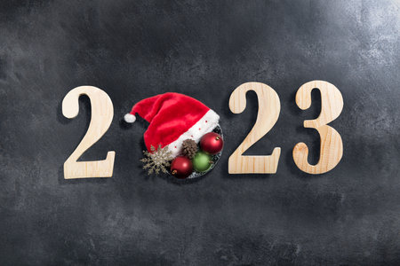 2023 with a Christmas decoration on black background. Happy New Year 2023の写真素材