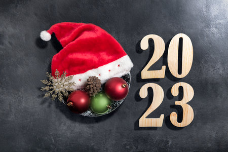 2023 with a Christmas decoration on black background. Happy New Year 2023の写真素材