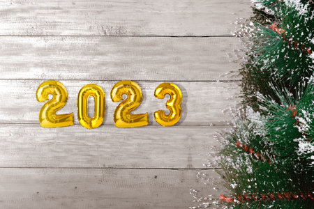 2023 with a Christmas tree on wooden background. Happy New Year 2023の写真素材