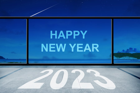 New Year greeting on window glass with a night scene. Happy New Year 2023