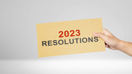 Human hand holding 2023 resolution message on the paper. Resolution of 2023. Happy New Year 2023