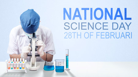 Asian male scientists using a microscope with colorful chemicals in laboratory glassware. National...