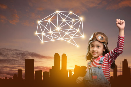 Asian little girl dreaming of something with a cityscape background. National Science Dayの写真素材
