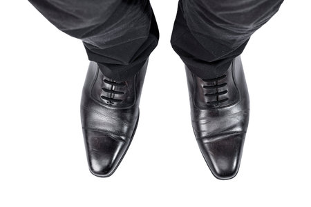 Closeup view of the businessman's foot isolated over white background
