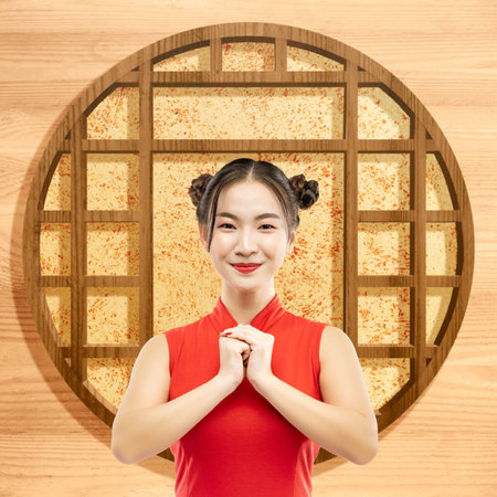 Asian Chinese woman in a cheongsam dress with congratulations gesture. Happy Chinese New Yearの写真素材