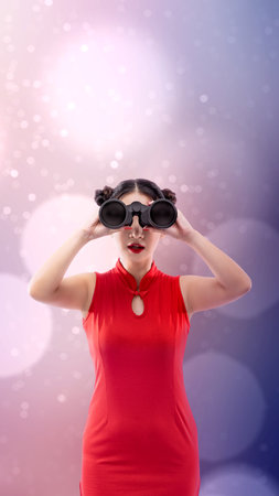 Asian Chinese woman in a cheongsam dress looking through binoculars. Happy Chinese New Year