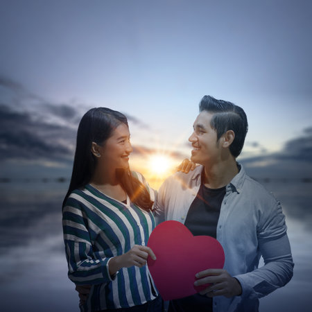 Asian couples holding the red heart. Valentines day