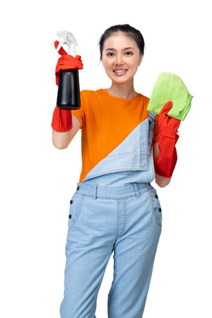 Asian young housewife in protective glove holding bottle sprayer and dry rag isolated over white backgroundの写真素材