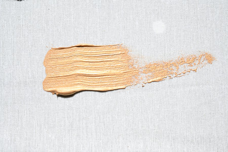 Golden brush stroke on white canvas