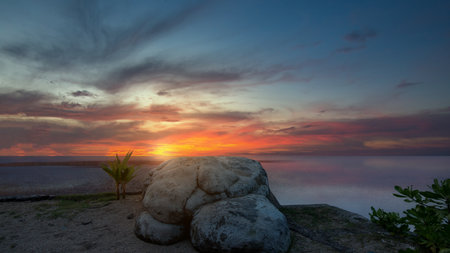 The landscape of a lake with a sunset sky backgroundの写真素材