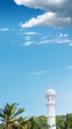 Mosque minaret on the field with blue sky backgroundの写真素材
