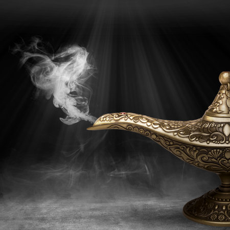 Golden Arabian lamp with white smoke on dark backgroundの写真素材