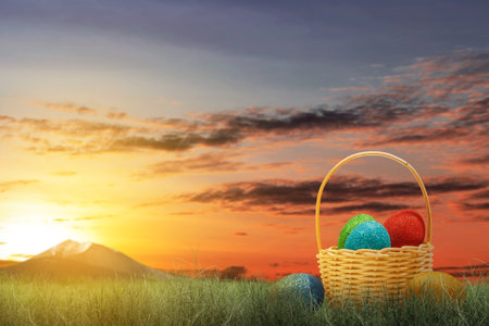 Colorful easter eggs in a wooden basket on the green grass. Easter Egg Conceptの写真素材