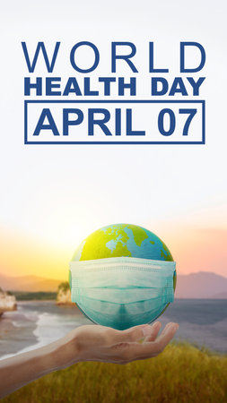 Human hand showing earth with a face mask. World Health Day Conceptの写真素材