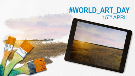 Paintbrush with a landscape on a white canvas. World Art Day conceptの写真素材