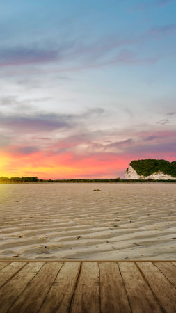 Wooden floor with views of sand dunes with a sunset sky backgroundの写真素材
