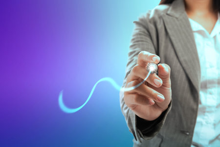 Businesswoman with a pen drawing a graph with colored backgroundの写真素材