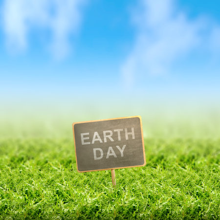 Wooden board with Earth Day message on the field. Earth Day Conceptの写真素材