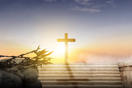 Christian cross and crown of thorns with sunset sky backgroundの写真素材