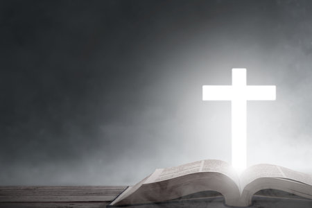 Christian Cross and open book with dark backgroundの写真素材