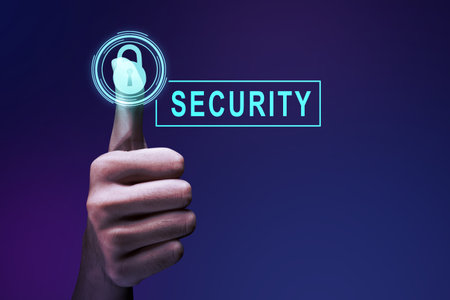A human hand pushes the virtual button with a security symbol on a colored backgroundの写真素材