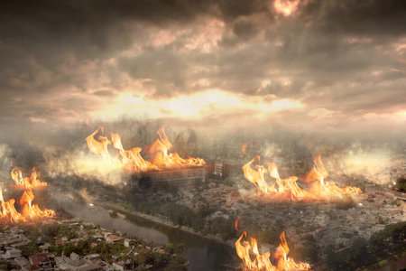 The ruined city with fires and sparks with a dark sky backgroundの写真素材