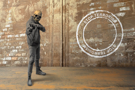 A man wearing a mask holding a gun with stop terrorism sign on a wall background