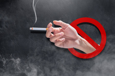 Closeup view of a man smoking a cigarette. World No Tobacco Day Conceptの写真素材