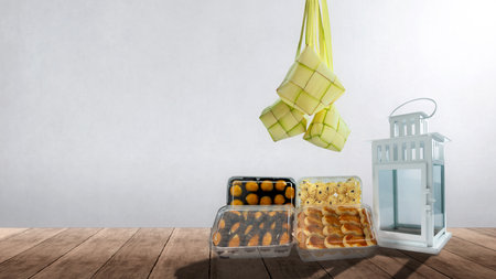 Assorted Indonesian cookies and Ketupat (Rice Dumpling) to celebrate eid al fitr (Kue Lebaran) on a colored backgroundの写真素材