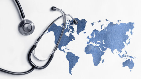 Stethoscope with world map on a colored background. World hypertension day conceptの写真素材