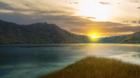 Beautiful lake view with hill and sunset scene backgroundの写真素材