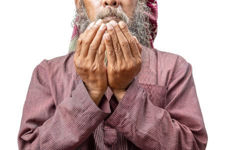 Muslim man with a beard wearing keffiyeh with agal in praying while raised hands isolated over white backgroundの写真素材