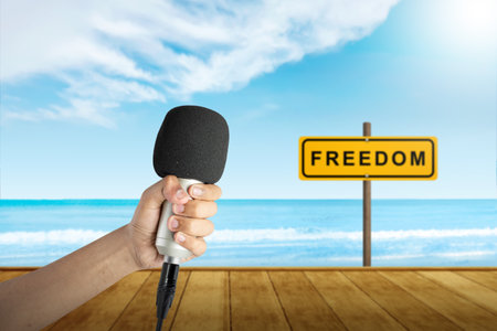 Human hand holding a microphone. World press freedom day conceptの写真素材
