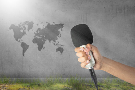 Human hand holding a microphone. World press freedom day conceptの写真素材