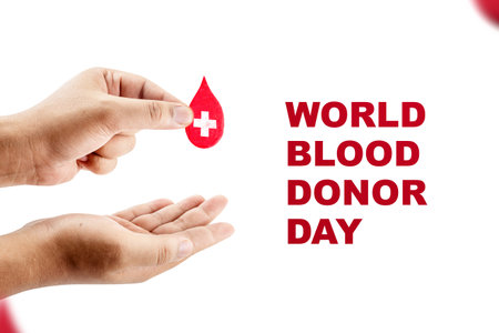 Human hand giving red blood drop. World blood donor day conceptの写真素材