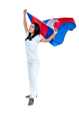 Asian women celebrate Cambodia independence day on 09 November by holding the Cambodia flag isolated over white backgroundの写真素材