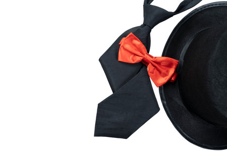 Black hat and black tie with red bow tie isolated over white backgroundの写真素材