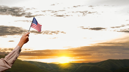 Human hand holding an American flag. 4th of July conceptの写真素材
