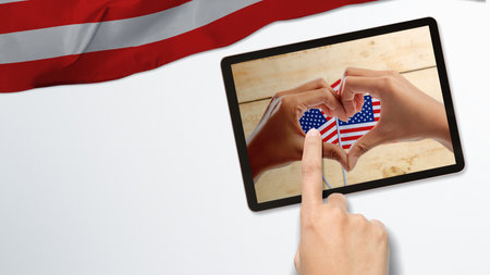 Human hand with a heart shape with an American flag. 4th of July conceptの写真素材