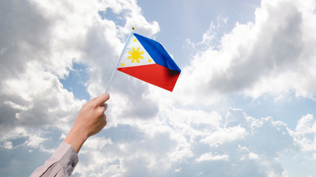 A human hand holding a Philippine flag. Philippines Independence Day concept