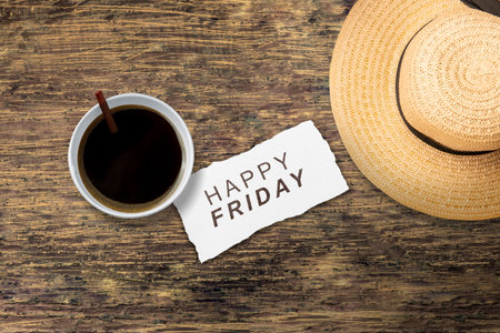Hat and coffee cup with a Happy Friday text. Happy Friday conceptの写真素材