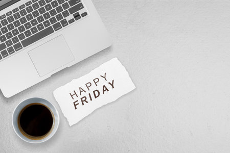 Laptop and coffee cup with a Happy Friday text. Happy Friday concept