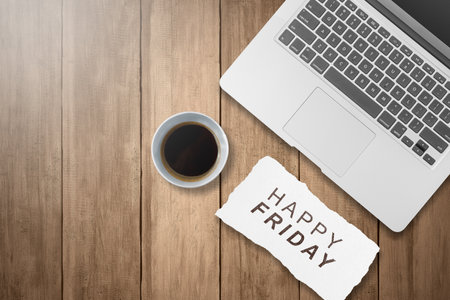 Laptop and coffee cup with a Happy Friday text. Happy Friday concept