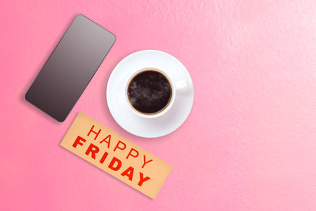 Mobile phone and coffee cup with a Happy Friday text. Happy Friday conceptの写真素材